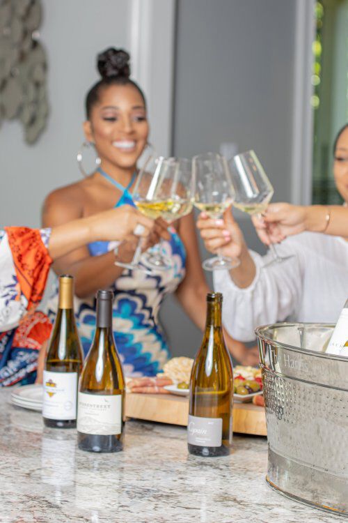 Toya Bush-Harris and friend celebrating with wine